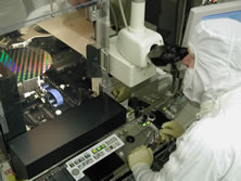 A technician checks individual wafers